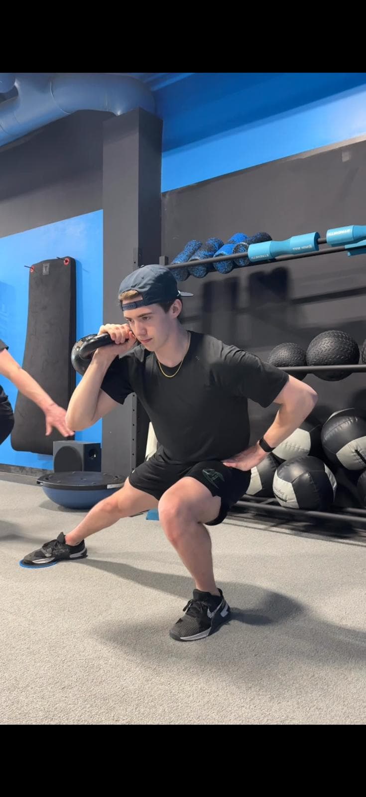 Athlete performing a strength and mobility exercise at Phyx Performance